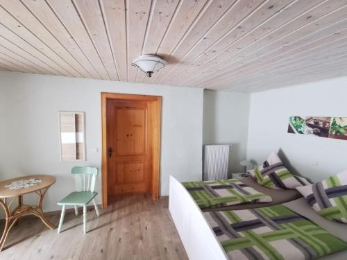 a bedroom with a bed and a wooden ceiling at Haus Peschl Fewo 1 in Neureichenau