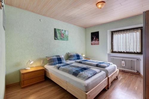 a bedroom with a bed with blue pillows on it at Apartment Alte Poststation in Wehr