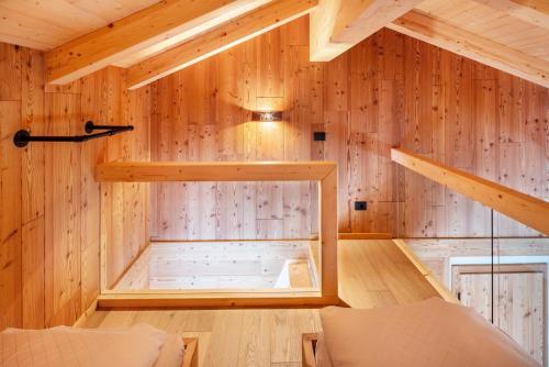 a room with a sauna in a wooden house at Noah Suites in Vigo di Fassa