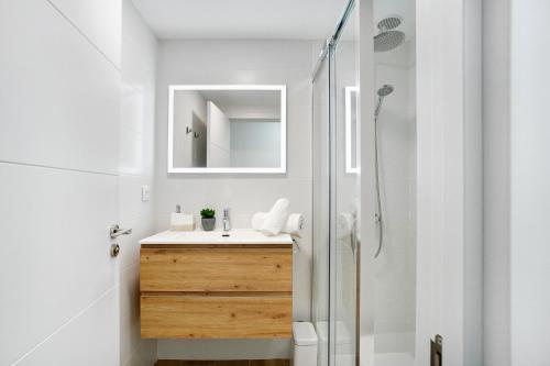 a bathroom with a sink and a shower at Liomor Luxury in Caleta De Fuste
