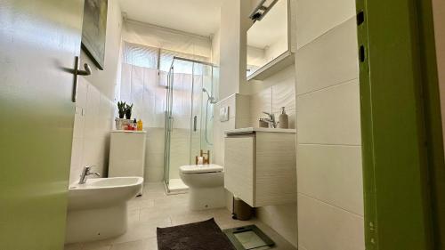 a bathroom with a toilet and a sink and a shower at A casa di Deborah in Padova