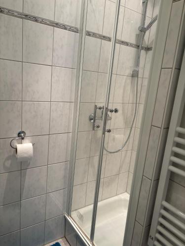a shower with a glass door in a bathroom at Apartment Dargies in Cuxhaven