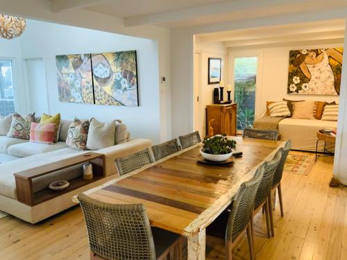 a living room with a table and chairs and a couch at The G Shack at Rennies Beach in Ulladulla