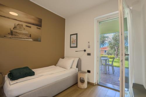 a bedroom with a bed and a door to a patio at Casa Titi in Malcesine