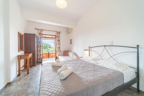 a bedroom with a bed with two white towels on it at Arianna Studio Ground Floor 5 in Paleokastritsa