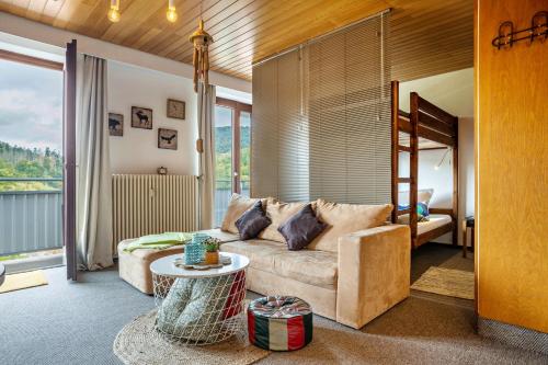 a living room with a couch and a table at Apartment Grundblick in Bad Grund