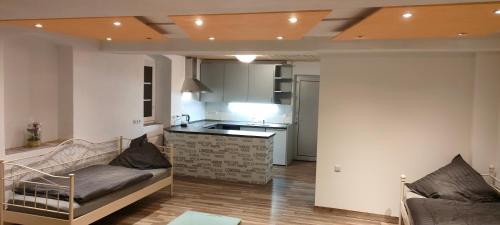 a living room with a couch and a kitchen at Käfer A in Waldbrunn
