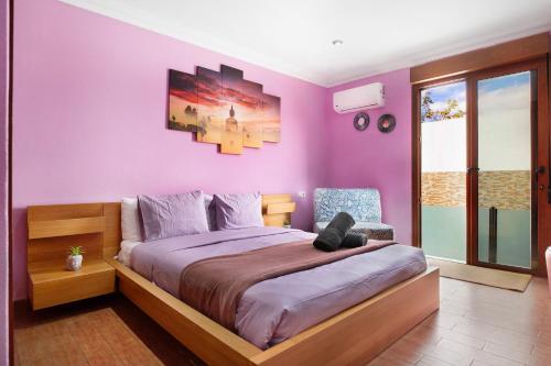 a purple bedroom with a bed with a teddy bear on it at Casa Barriguita in Yaiza