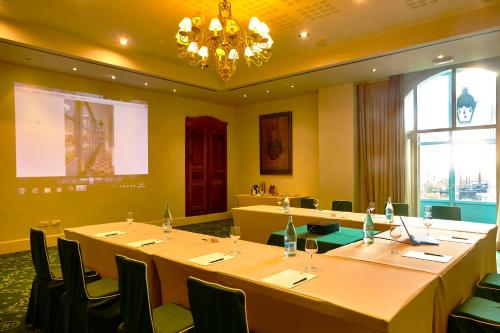 a conference room with tables and chairs and a chandelier at Hotel Palacio Urgoiti in Mungia