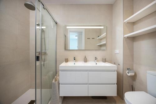 a bathroom with a white sink and a mirror at Horus 051 in Torre del Mar