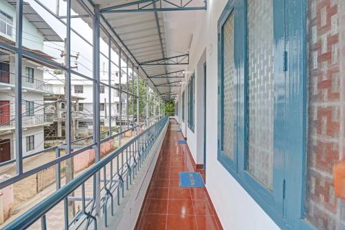 an empty corridor in a school building with blue windows at Hotel O Skywind in Trivandrum