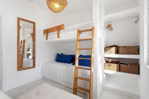 a bedroom with a bunk bed and a mirror at Casa da Praia Valmitão in Ribamar
