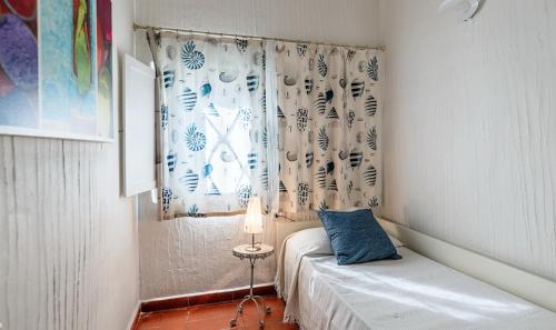 a small bedroom with a bed and a window at Casa 2 in Castiadas