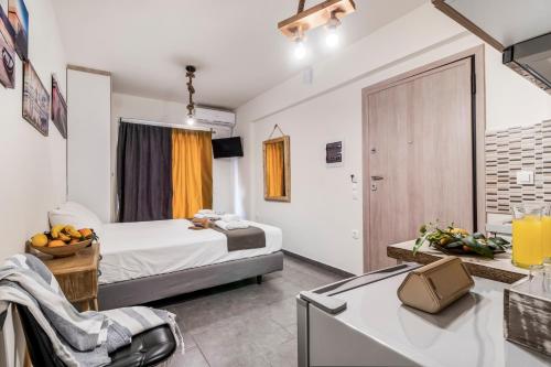 a bedroom with a bed and a kitchen with a sink at Oceanida Aelia Room 2 in Nikiana