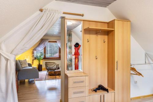 a room with a bed and a room with a dresser at Ferienhaus Felsenblick in Rippershausen