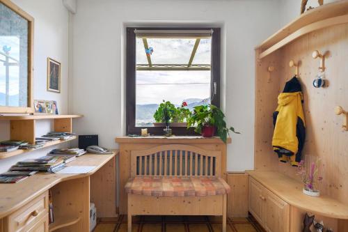a home office with a wooden desk and a window at Harmony Apt 2 in Appiano sulla Strada del Vino