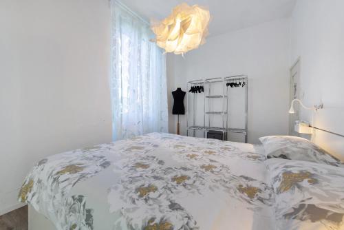 a bedroom with a bed and a chandelier at Villa Carla in Salò