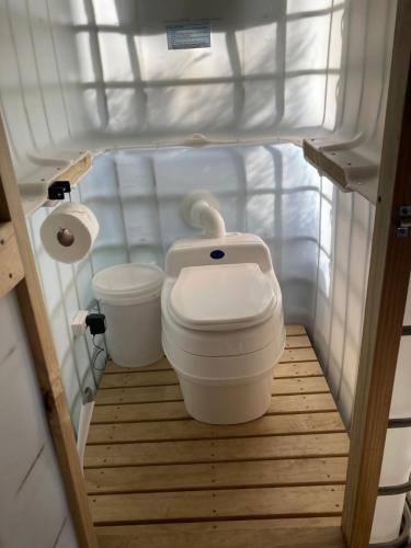 a small bathroom with a toilet in a room at Fantail Point - secluded cabin with stunning views and outdoor bath in Upper Papamoa