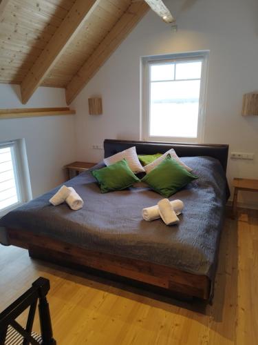 a bedroom with a large bed with green pillows at Kleine Auszeit 1 in Forst