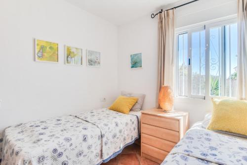 a bedroom with two beds and a window at Villa Costabella in Marbella
