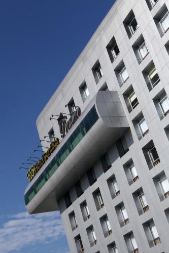 a building with a sign on the side of it at Santika Premiere Dyandra Hotel & Convention - Medan in Medan
