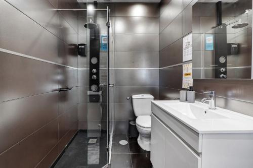 a bathroom with a toilet and a sink and a shower at Vitóriahouse - Your Little Corner in Vila Nova de Gaia