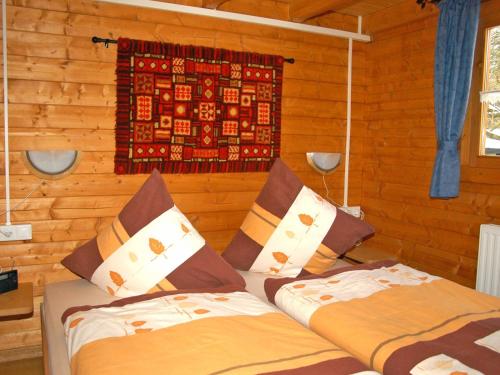 a bedroom with two beds and a tapestry on the wall at Ferienhaus Pöttgen in Arnsberg