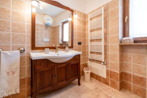 a bathroom with a sink and a mirror and a tub at Trulli Orma in Martina Franca