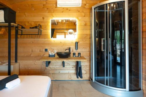 a bathroom with a sink and a toilet in a room at Les Chalets De Tesa in Occhiatana
