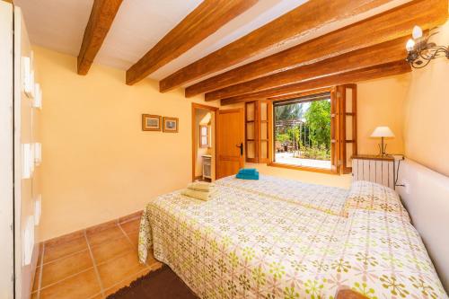 a bedroom with two beds and a window at Can Colau in Santa Margalida