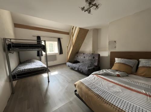a bedroom with a bunk bed and a chair in it at Gite de scène in Chamesson