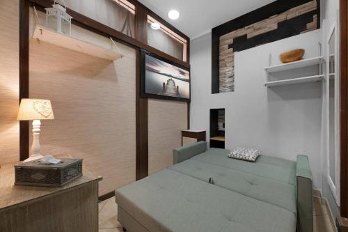 a living room with a couch and a tv at La Casa di Lu - Val D'Intelvi in Lanzo dʼIntelvi
