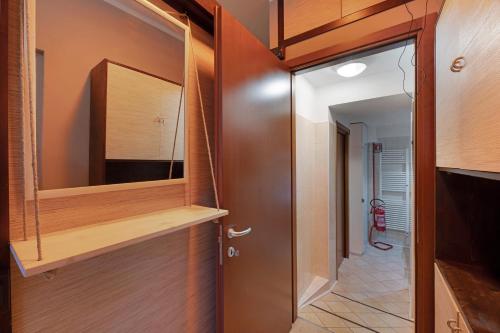 a hallway with a door and a mirror at La Casa di Lu - Val D'Intelvi in Lanzo dʼIntelvi