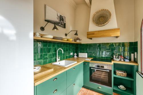 a kitchen with blue cabinets and a sink and a basketball hoop at El Pedró Panoramic in Ventalló