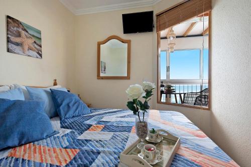 a bedroom with a bed with a tray with flowers on it at Marazul in Tacoronte
