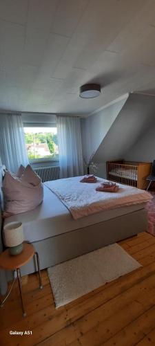 a large bed in a room with a window at Ferienwohnung an der Lahn in Limburg an der Lahn