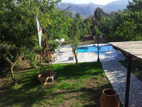 a view of a yard with a pool and a flag at Zeus House in Agios Konstantinos