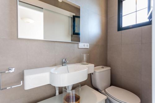 a bathroom with a sink and a toilet at Villa Banyalbufar in Banyalbufar
