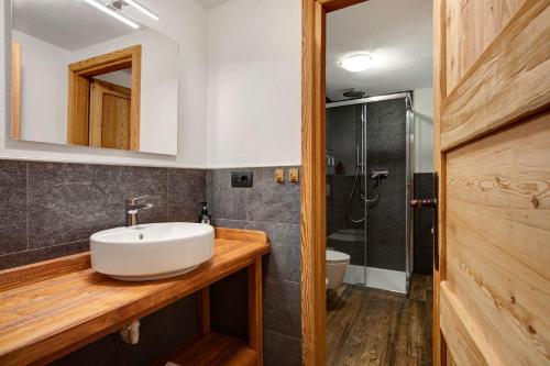 a bathroom with a sink and a shower at Aux Pieds du Malatra' 2 in Saint-Rhémy-en-bosses