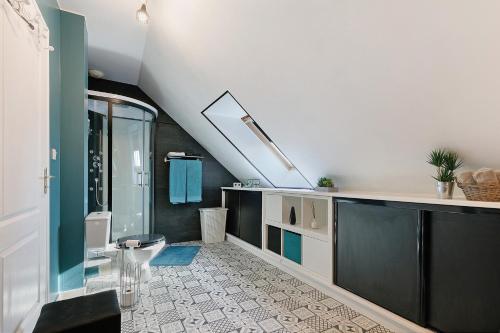 a bathroom with a sink and a toilet in a room at Chambres d'Hôtes - Les Boubous in Saint-Nazaire