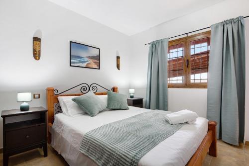 a bedroom with a large bed and a window at Casa Glory in Antigua