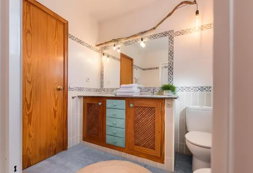 a bathroom with a toilet and a sink at Villa Can Marsa in Santa Eularia des Riu