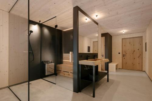 a bathroom with a shower and a sink and a mirror at anders mountain suites 2 in Brixen