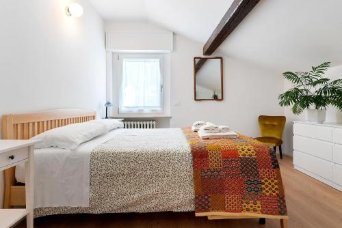 a bedroom with a bed and a table and a mirror at The View in Levico Terme