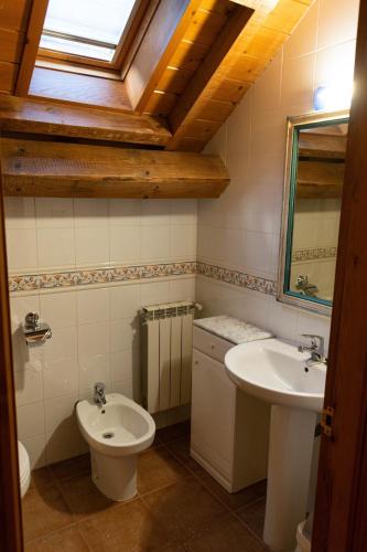 a bathroom with a toilet and a sink at Kabila Enea 1 in Uztárroz