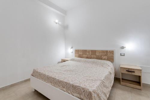 a white bedroom with a bed and a desk at Villa Bludea - Salento in Torre Lapillo