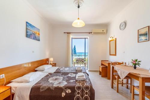 a bedroom with a bed and a table and a desk at Mires House Front Studio 1 in Agios Gordios