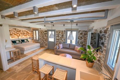 a living room with a couch and a table at Celini Villas Tinos in Tinos