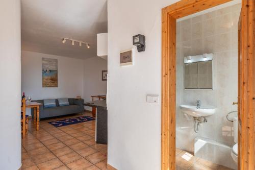 a bathroom with a toilet and a sink in a room at Casa Eden in Tías
