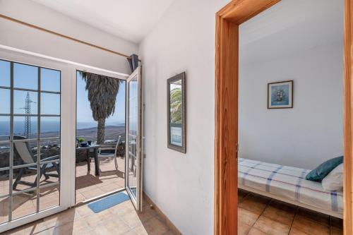 a bedroom with a view of the ocean at Casa Eden in Tías